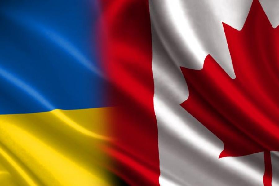 A portion of the Ukraine flag and Canada flag layered next to each other.