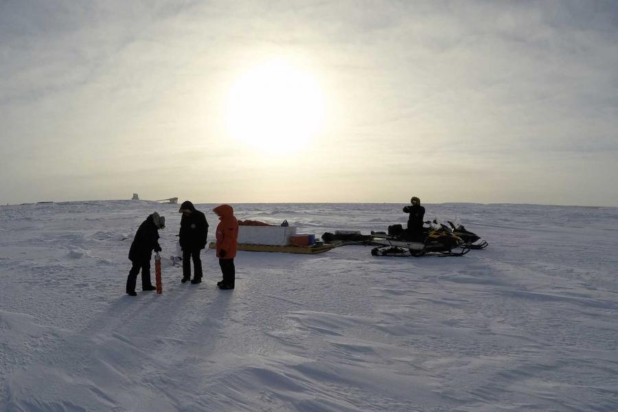 a research team collecting ice cores.