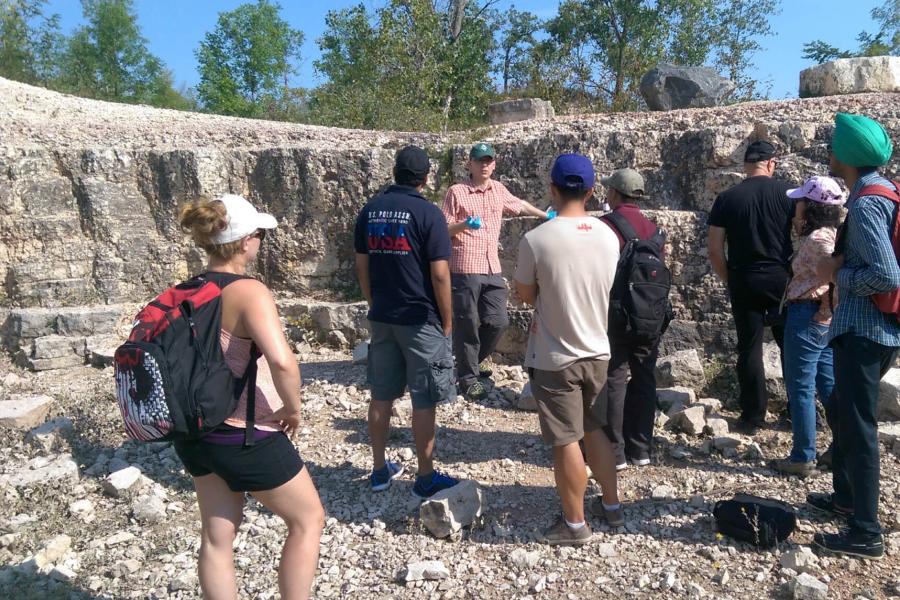 An engineering advisor and students visiting a limestone quarry.