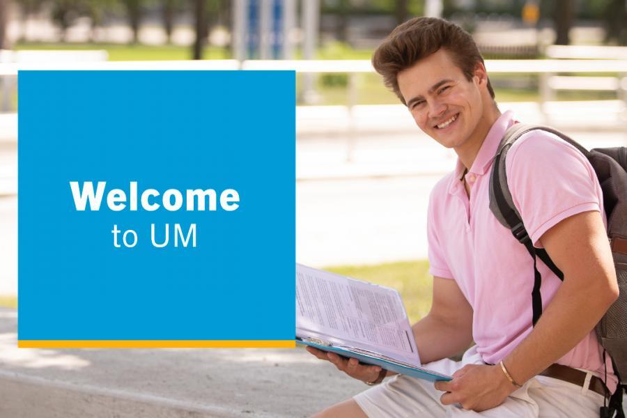Text in a box laid over top of a young male student smiling. The text reads: "Welcome to U.M."