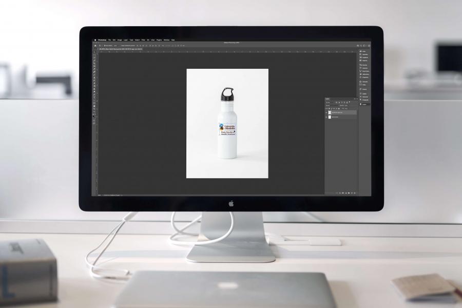 Graphic design work can be seen on a desktop monitor.
