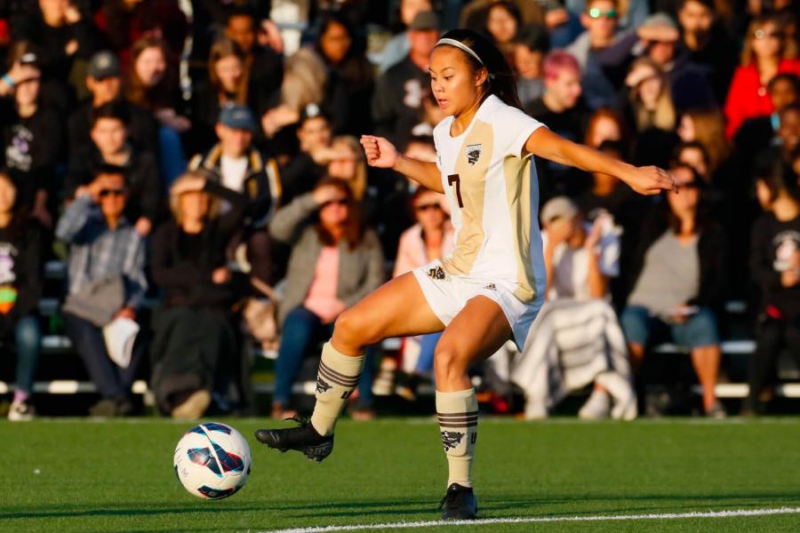 A Bisons women's soccer player preparing to kick the ball.