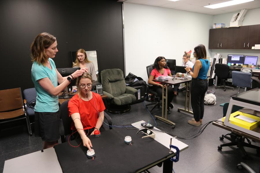 researcher and students conducting research in motor integration lab