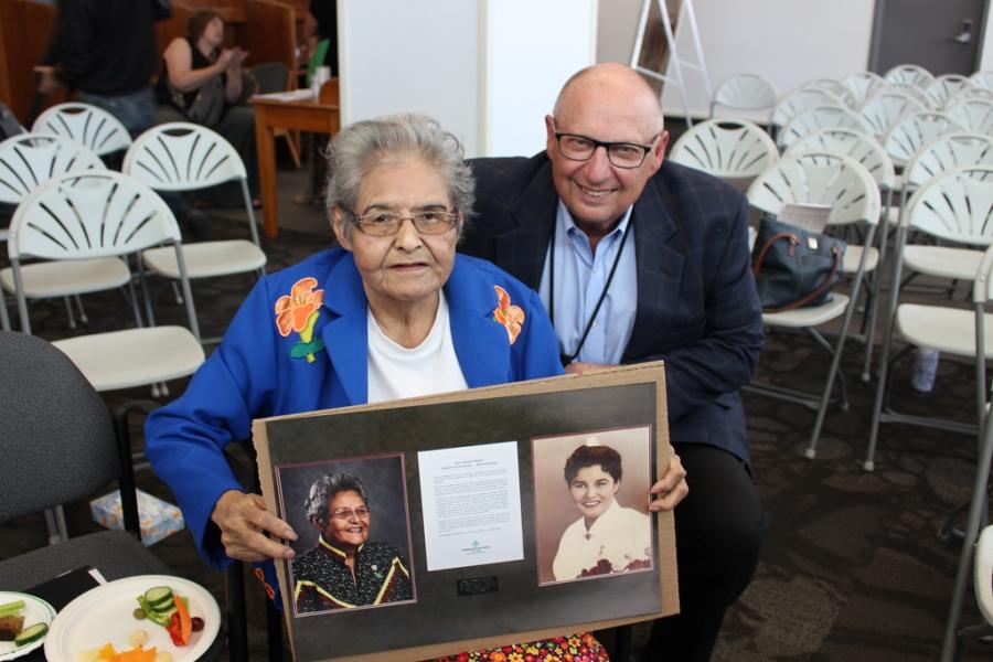 Dr. Brian Postl with an Indigenous Elder, holding a portrait.