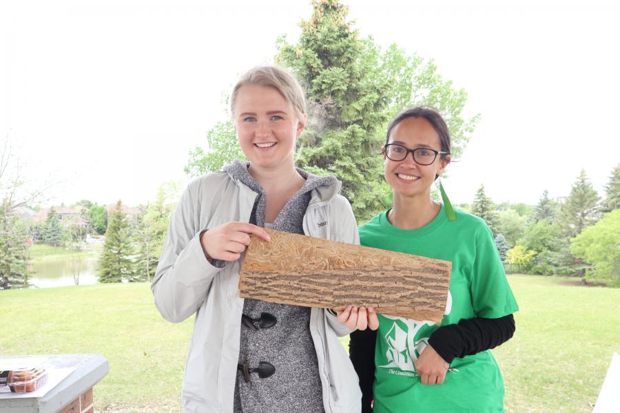 two students from biological sciences coop field work smiling at the camera