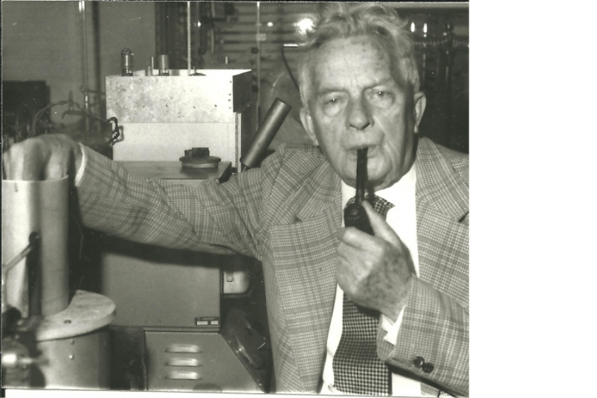 Allan Campbell holding a pipe. The photo is in sepia color.