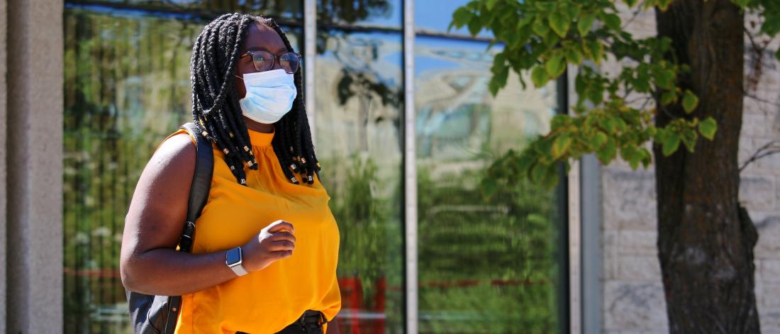 Student in mask on University of Manitoba campus.