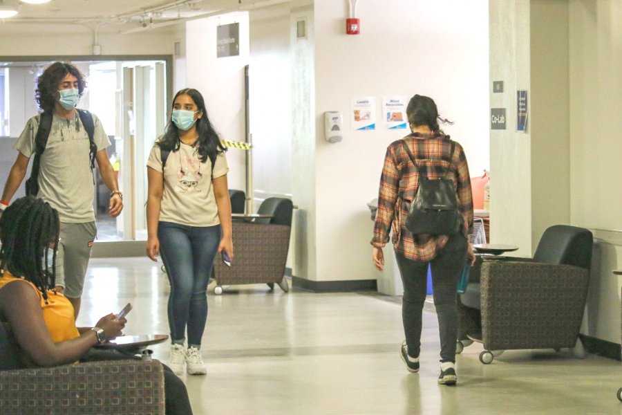 Students wearing masks walking in hallways