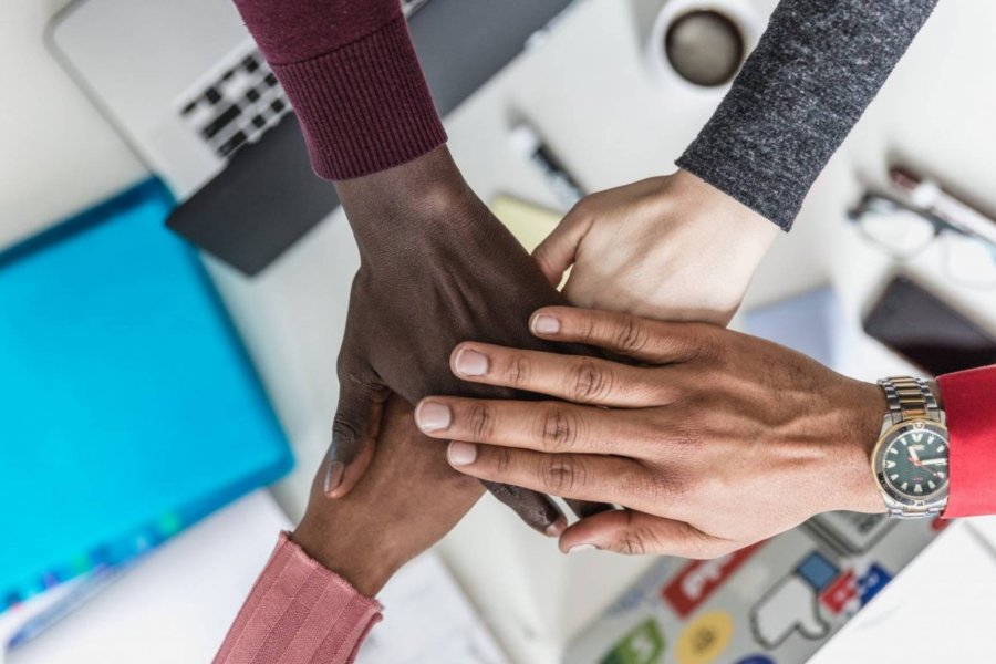 Four hands on top of each other hand