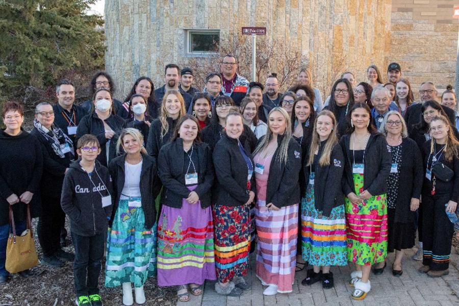 Participants in the 2022-2023 Indigenous Circle of Empowerment (ICE) surrounding by elders, ICE alum, community leaders and loved ones posing for a picture.