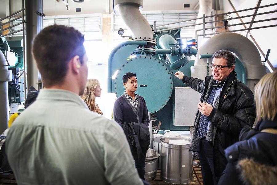 The university engineer showing students the inside of the UM powerhouse