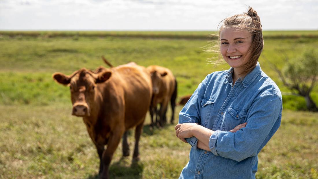 Animal science hero student with cow
