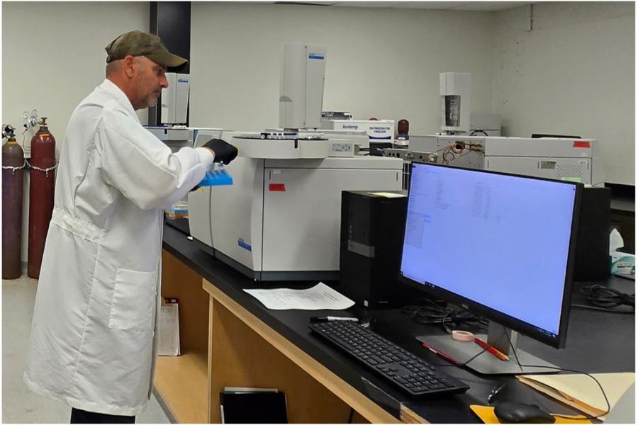 Techician operating Gas Chromatograph