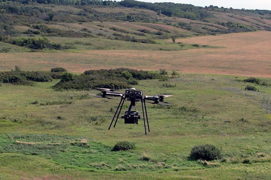 Agriculture drone flies over a field