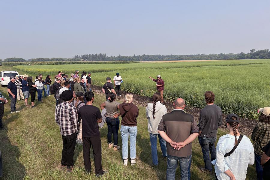 People attend a lecture in a field in Carmen Manitoba