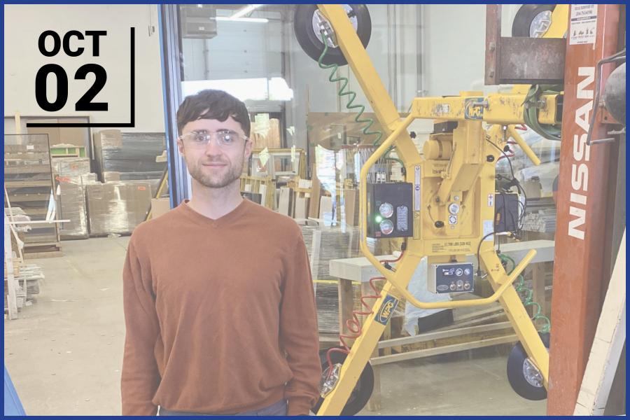 student standing in a warehouse
