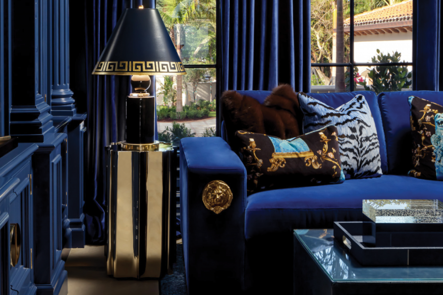 blue couch with a lamp beside and coffee table in front