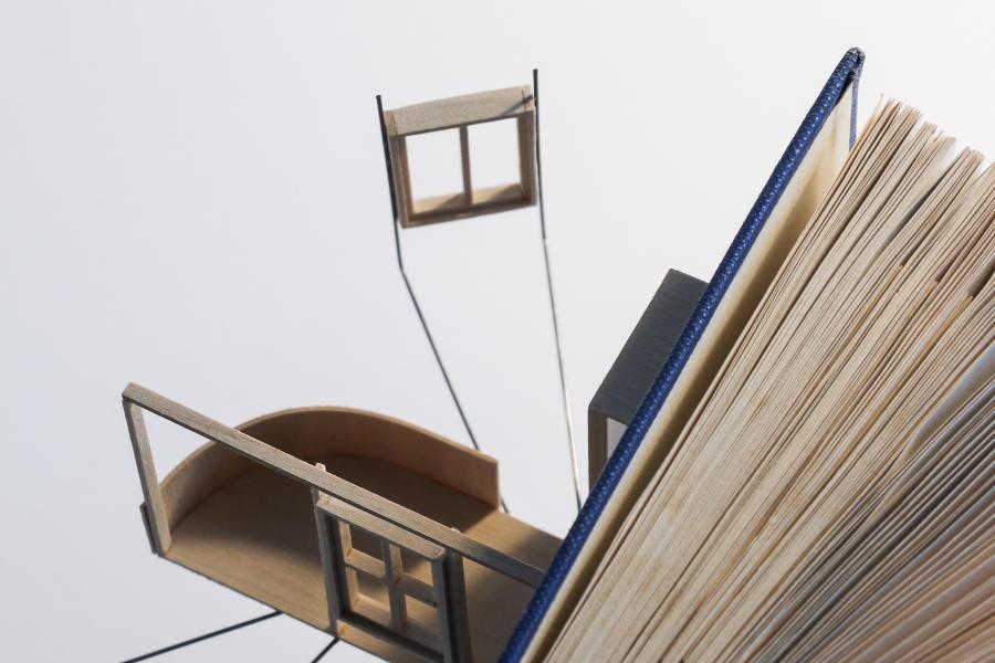 Model attached to a book.