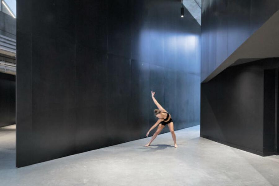 Industrial looking hallway with dancer