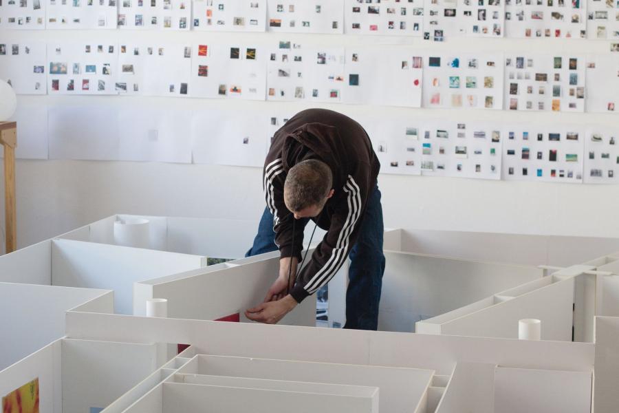 Photo of person setting up gallery exhibition.
