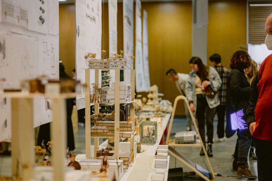 architectural models on display in linear path across the image