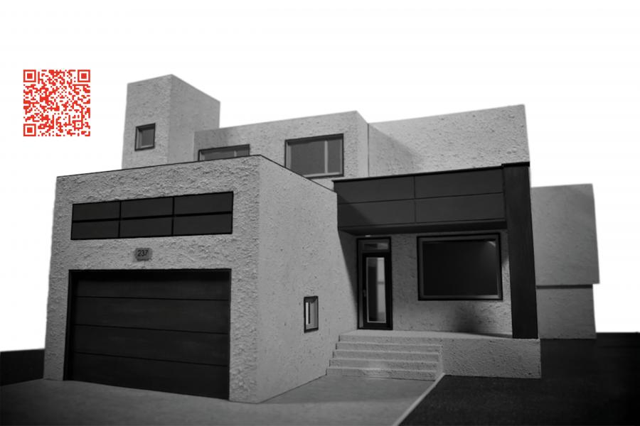 Modern, minimalist house model in grayscale with angular shapes and large windows. A red QR code is visible in the upper left corner. Calm, sleek vibe.
