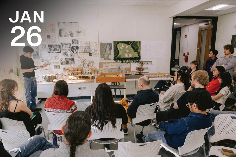 A man presents architectural models to an attentive audience in a classroom. The room is adorned with sketches and diagrams, creating an educational atmosphere.