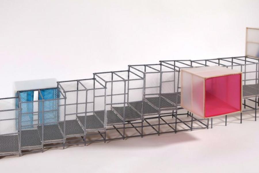 A geometric architectural model features a series of connected cubic frames with mesh sides, highlighted by a blue cube and a vibrant pink cube. The design conveys a modern, minimalist aesthetic.