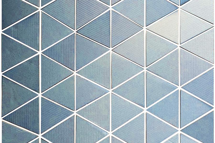 Blue triangular tiles form a geometric pattern against a light background. The clean lines and cool tones create a modern, tranquil aesthetic.