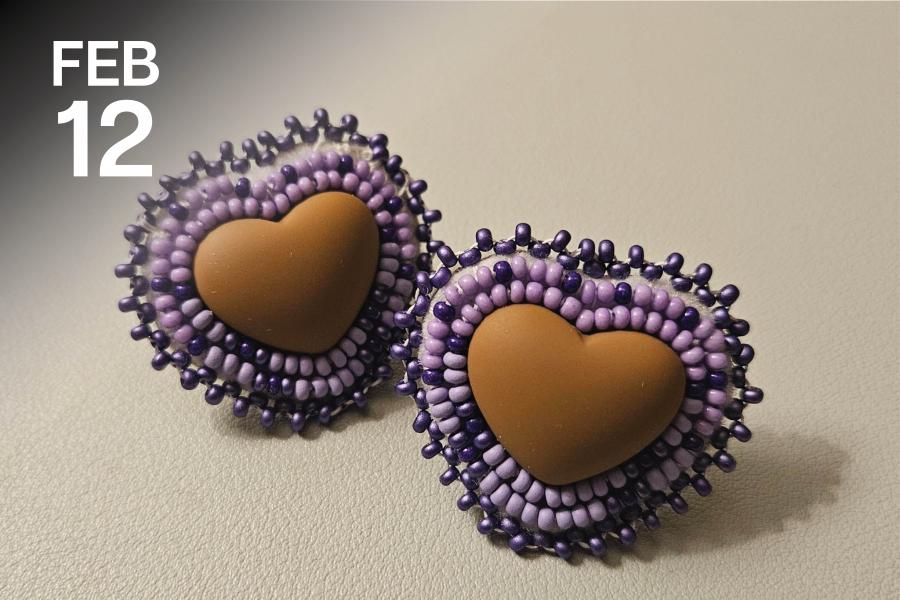 Two handmade heart-shaped earrings with brown centers, surrounded by concentric circles of purple and lavender beads, creating a warm, artisanal feel.