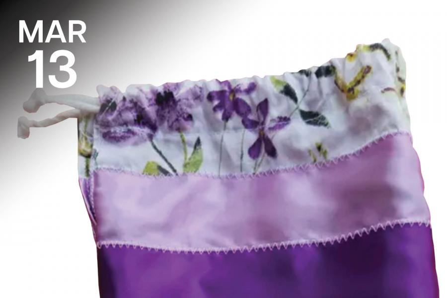 A drawstring bag with floral patterns in purple and lavender stripes.