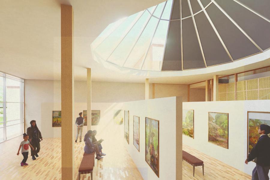A bright, spacious art gallery with a skylight ceiling, wooden floors, and modern decor.