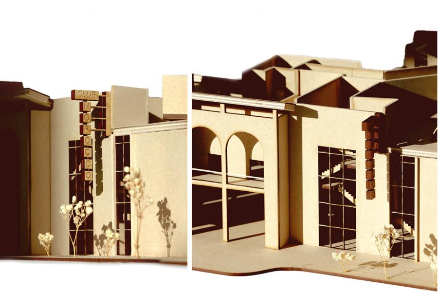 Architectural model showing a building with large windows, arched structures, and a vertical sign.