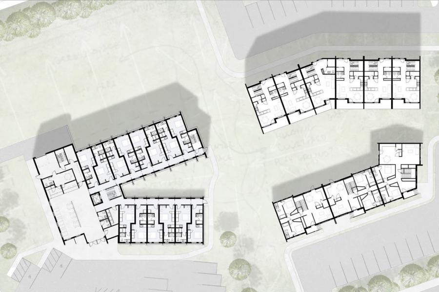 Floor plan of a building complex, showing three structures with rooms outlined. Surrounding areas have parking spaces and greenery.