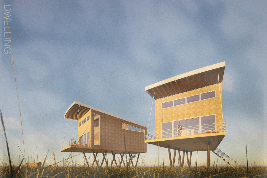 Modern stilted houses with large windows set against a clear blue sky, surrounded by grassy fields. 