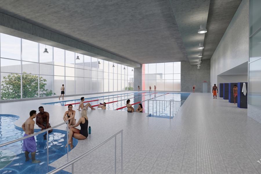Indoor swimming pool with large windows. Several people relax in a hot tub, while others swim or chat poolside.