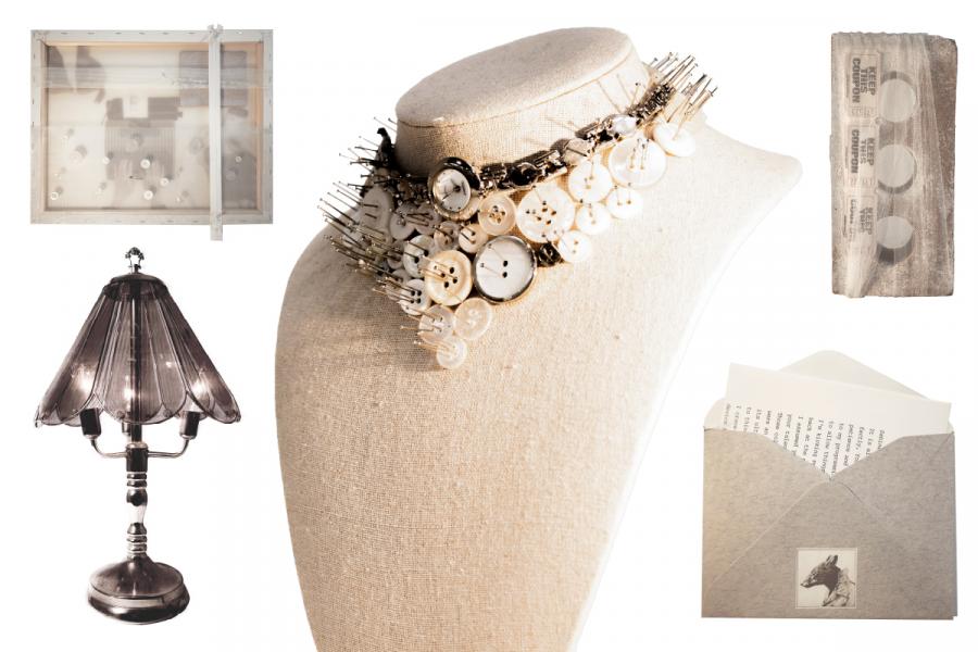 A fabric mannequin displays a necklace of pins and vintage buttons. 