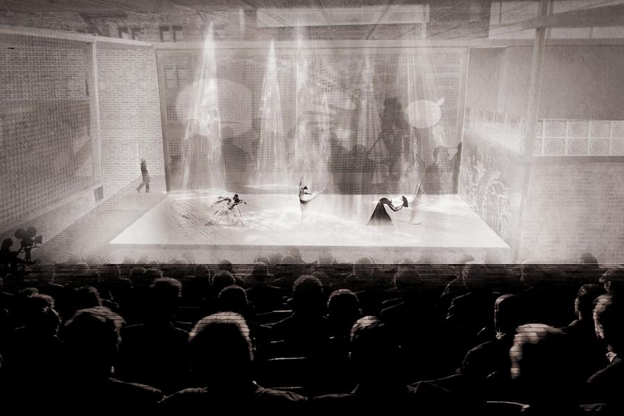 A dramatic stage features ethereal dancers under beams of light, set in a dim theater.