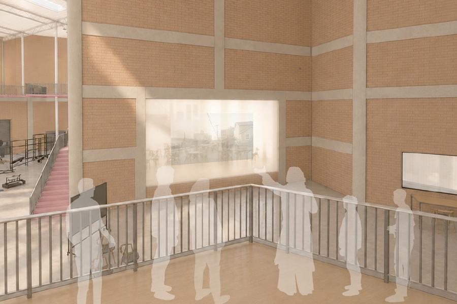 Silhouetted figures stand on a mezzanine in an art gallery, viewing a large illuminated artwork on a brick wall.