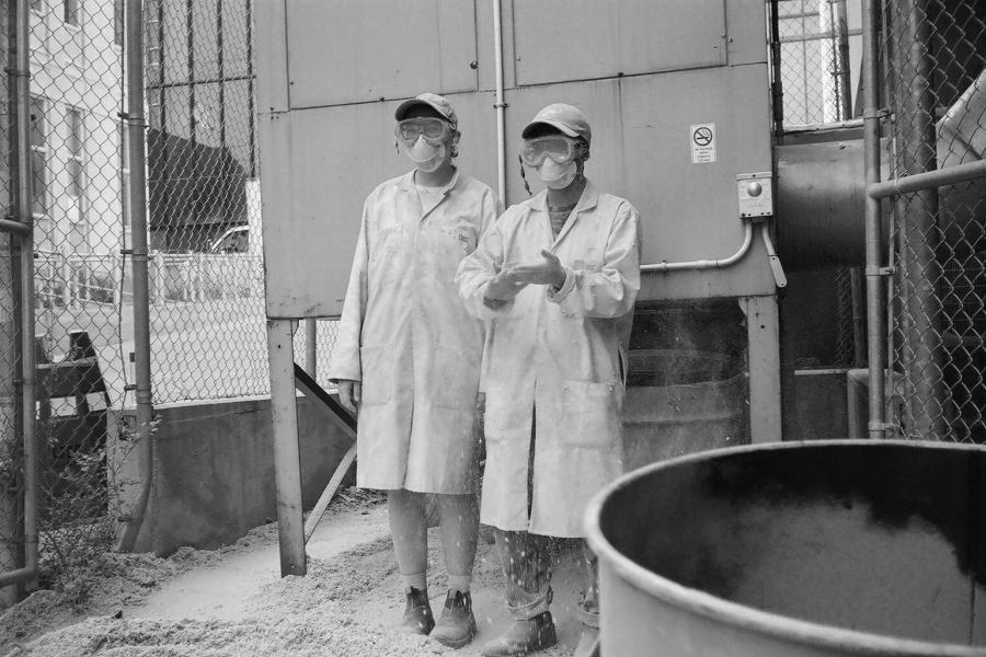 2 people in labcoats and PPE