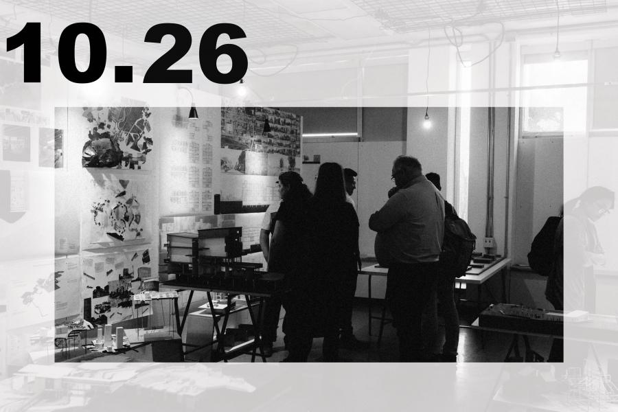 Black-and-white photo of visitors viewing artwork and displays in a creative studio or gallery.