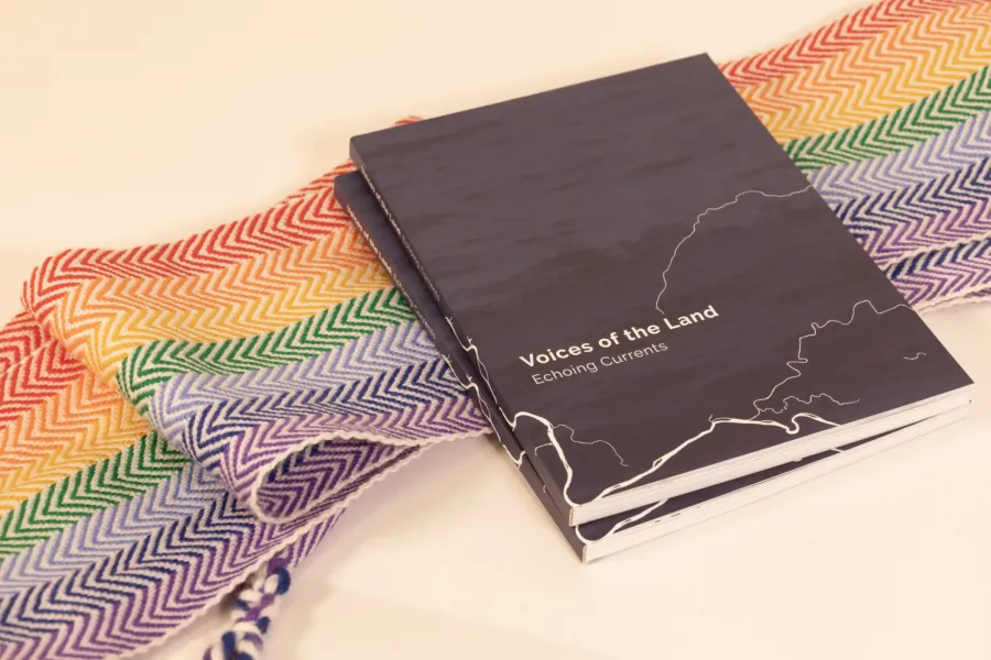 rainbow scarf with books laying over it