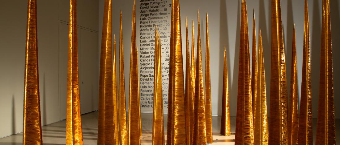 Minimalist golden spire installation emphasising verticality and light play