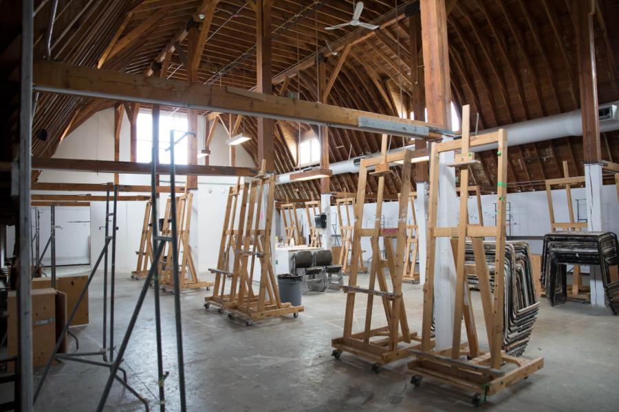 The spacious painting space inside the Art Barn with large easels placed around the room.