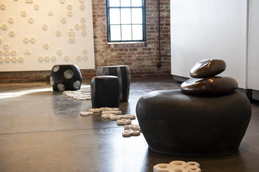 A series of ceramic works lined up organically in a row