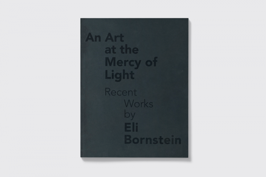 Dark blue book cover with darker blue text reading "An Art at the Mercy of Light".