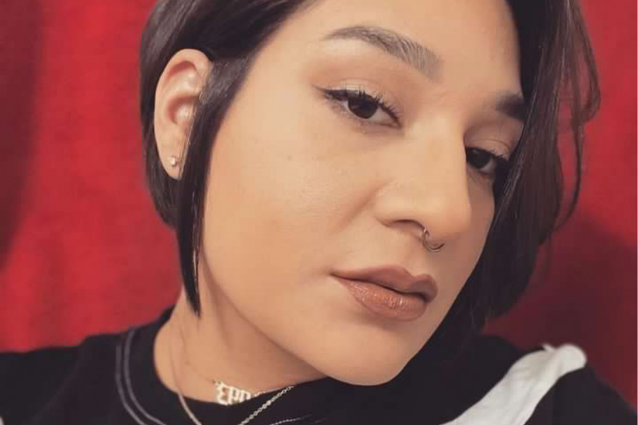 headshot of Sadie Lavoie with short ear length black hair, head tilted staring into camera.