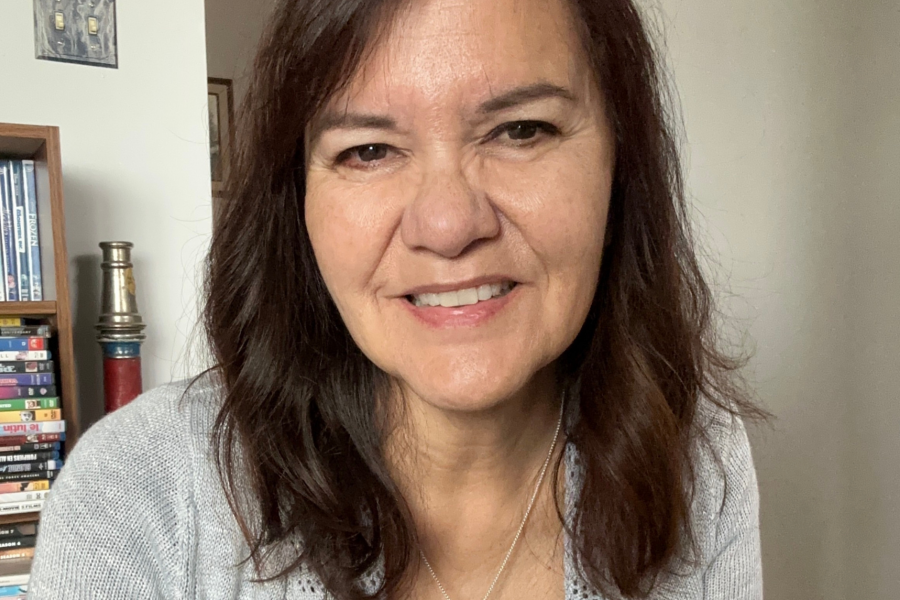 Dr. Suzanne McLeod smile towards the camera wearing a light grey, blue cardigan.