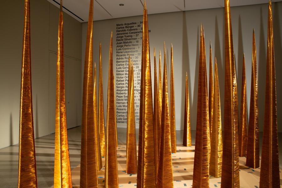 Minimalist golden spire installation emphasising verticality and light play