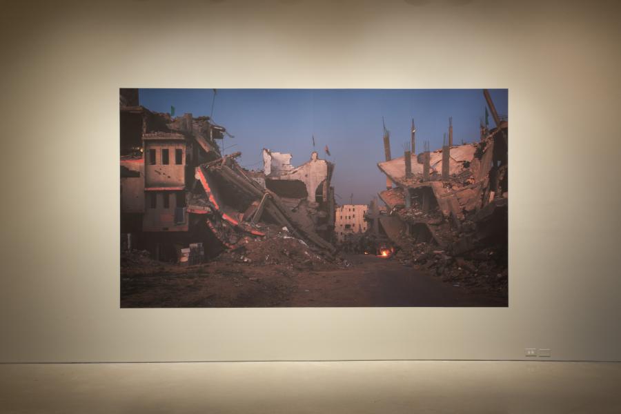 Close-up view of a photograph depicting the aftermath of urban destruction at Lidwien van de Ven's exhibition.